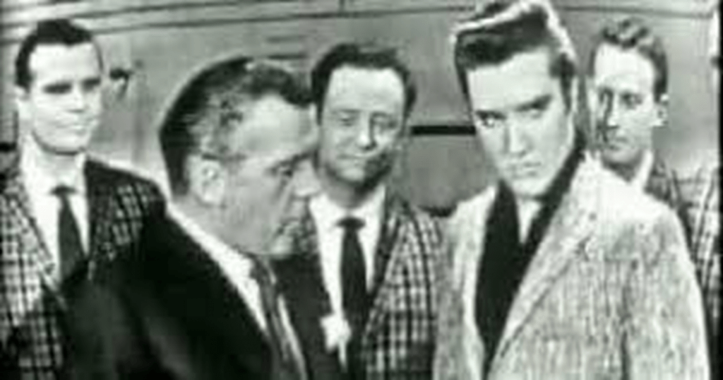 Ed Sullivan praising Elvis as The Jordanaires look on.
