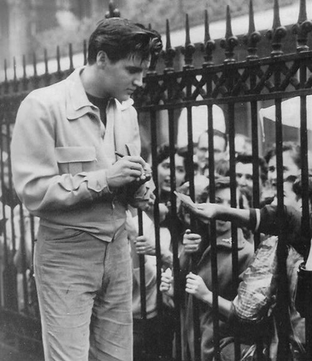 Elvis signing autographs whilst filming on location in New Orleans.